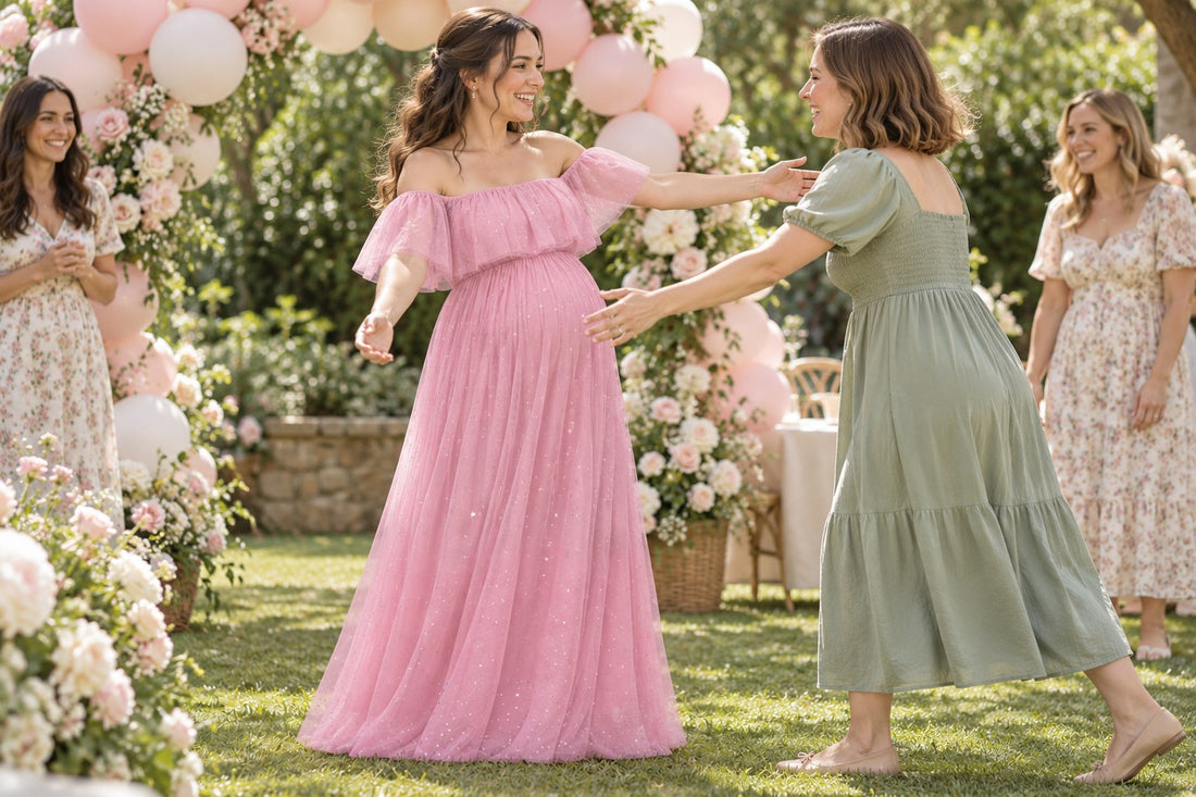 Mom-to-be in a dusty pink off-shoulder maternity dress greeting a friend under a balloon arch