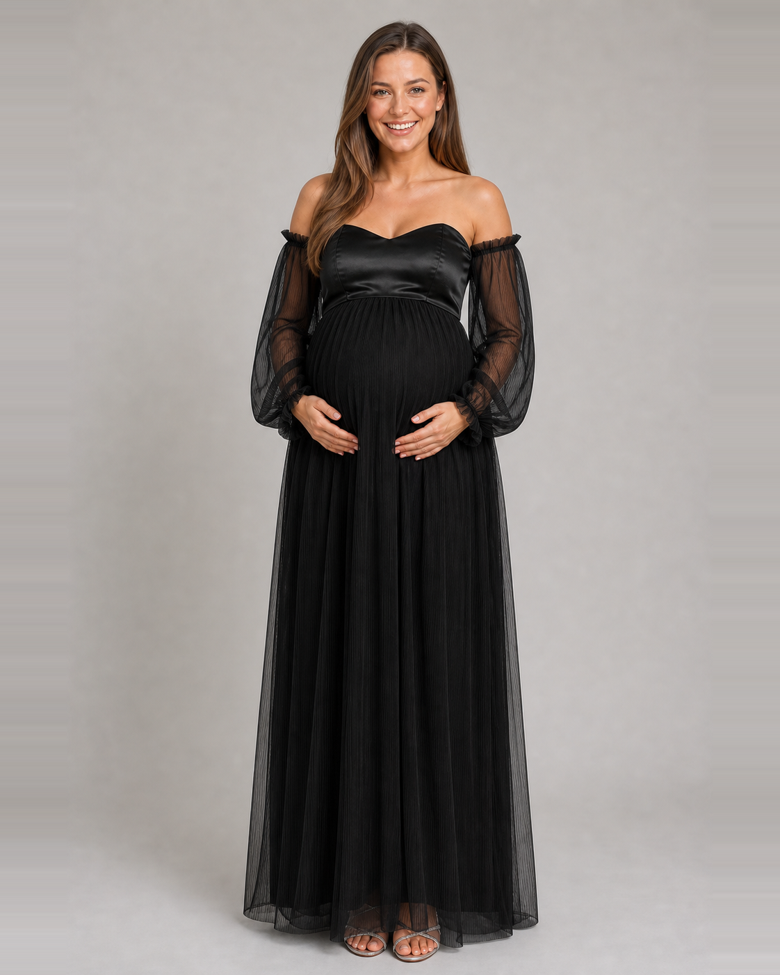 Front view of the black maternity gown with an off-shoulder sweetheart neckline and full-length pleated skirt.