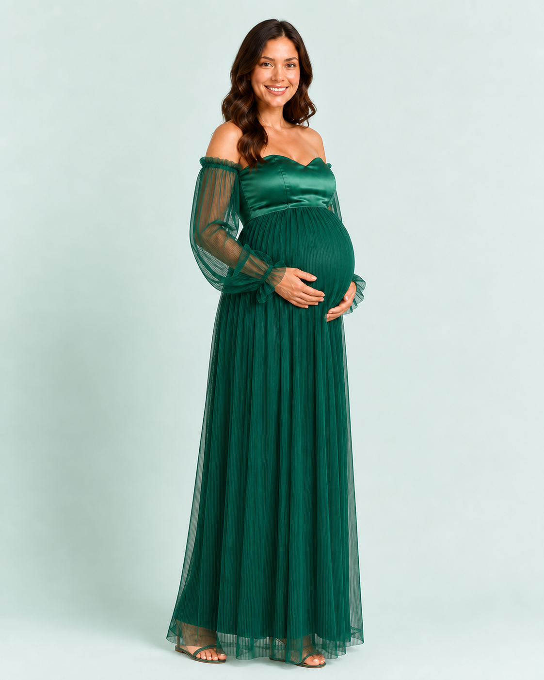 Three-quarter view of the deep green gown showing the raised waist and pleated skirt over its lining.