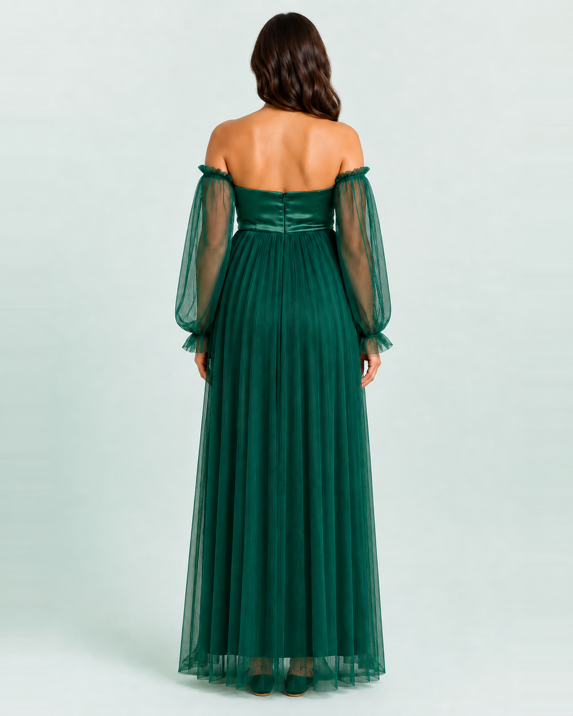 Back view of the deep green gown showing the center-back bodice closure and sheer long sleeves.