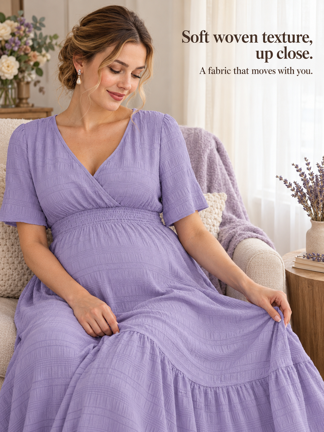 Eugenie Lavender maternity dress — seated on an armchair, skirt pooling