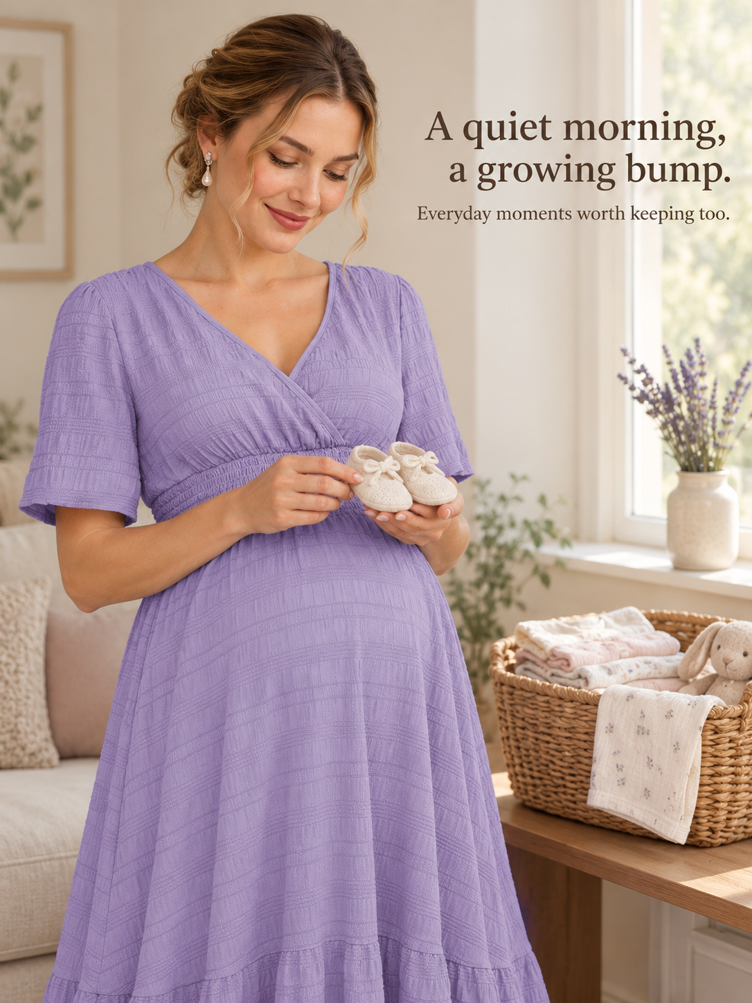 Eugenie Lavender maternity dress — holding small baby shoes indoors