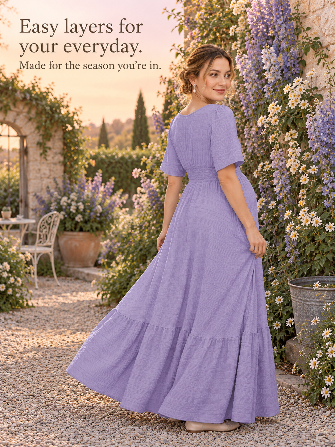 Eugenie Lavender maternity dress — walking along a garden path outdoors