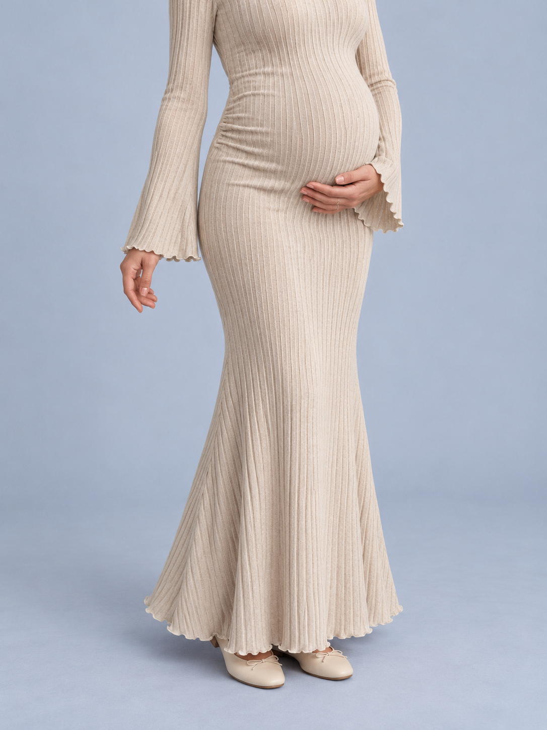 Lucienne Oatmeal maternity dress — close-up of the fitted waist and fishtail hem flare