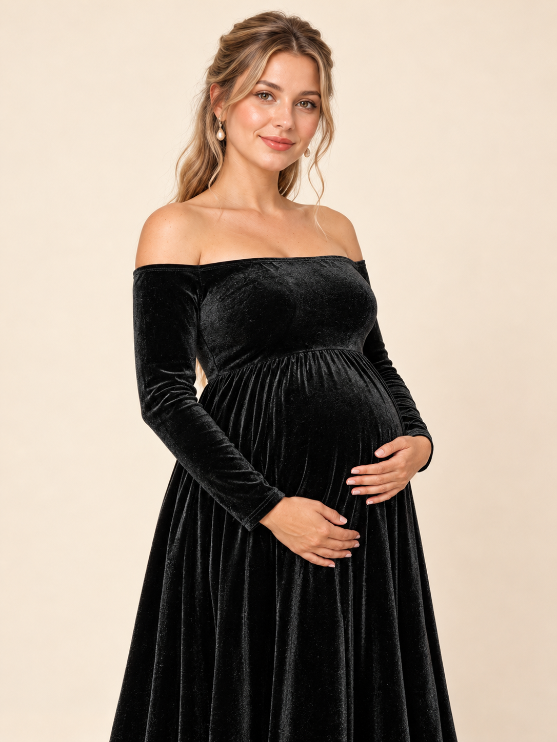 Colette Black maternity dress — front view with hands cradling the belly