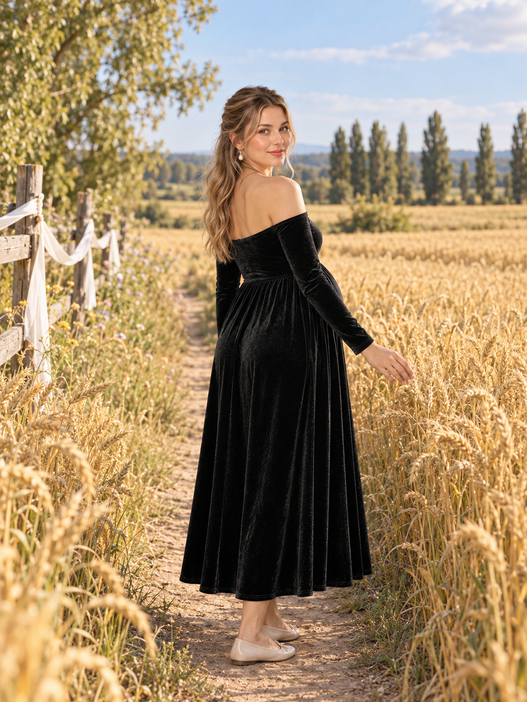 Colette Black maternity dress — walking along a path through a golden wheat field