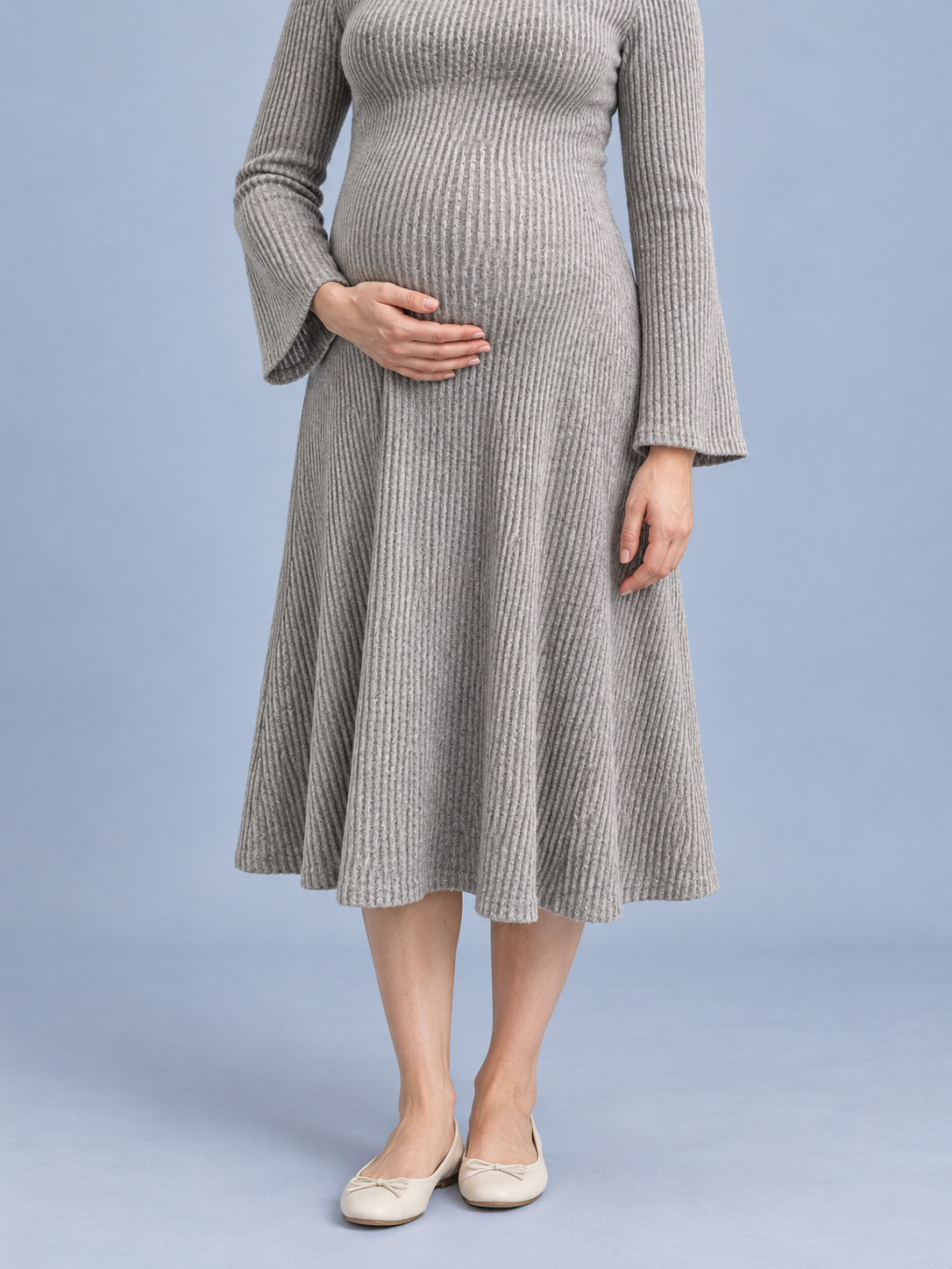 Simone Oatmeal Heather maternity dress — A-line skirt close-up with hand on belly