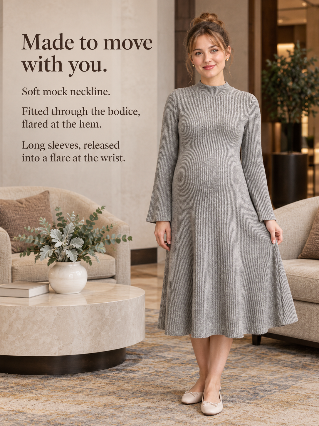 Simone Oatmeal Heather maternity dress — standing in a sunlit living room near fresh flowers