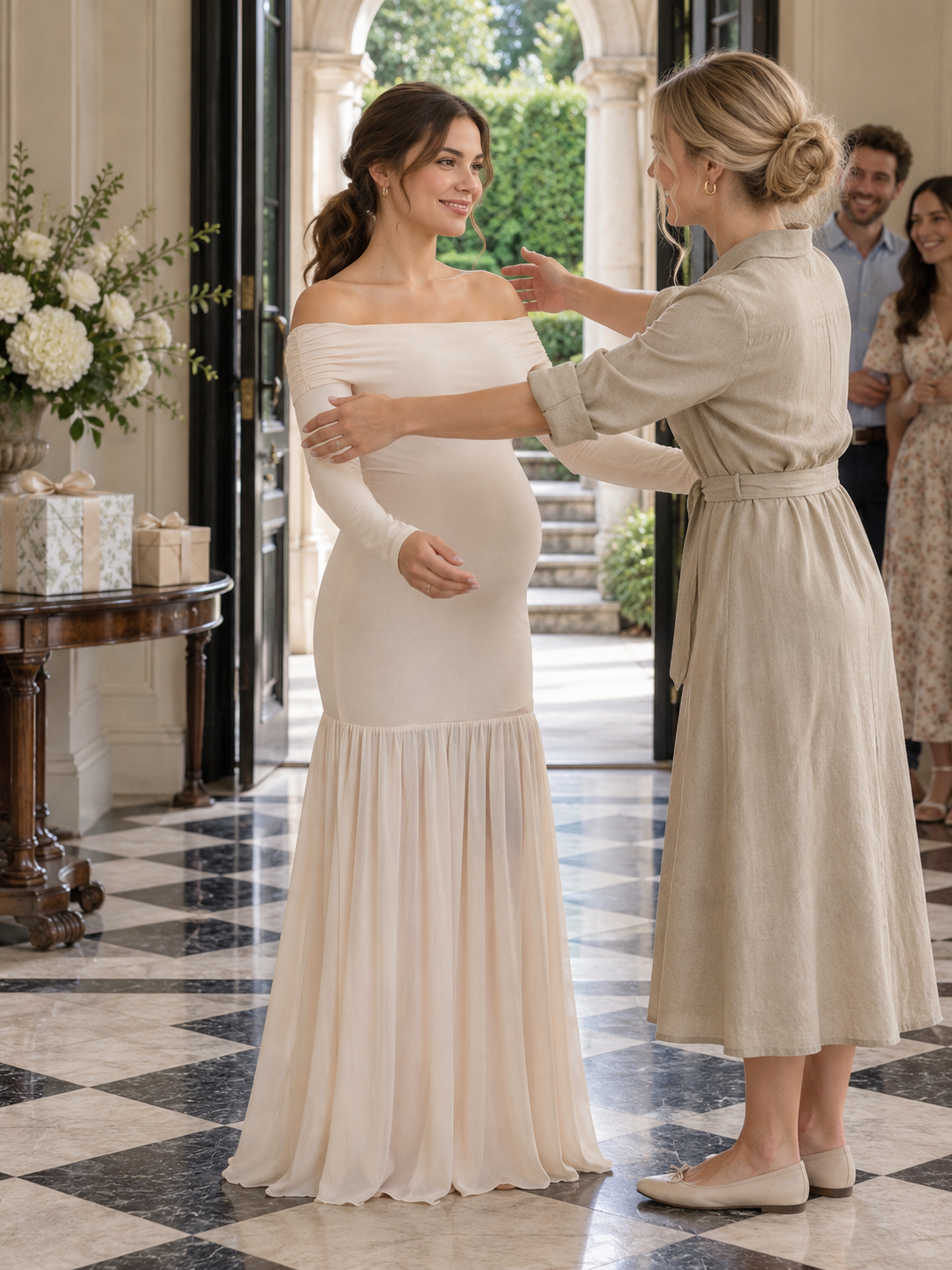 Gabrielle Champagne Beige maternity dress — greeting a guest in a marble-floored entryway
