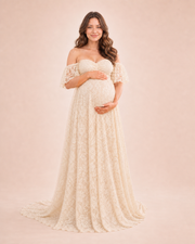 Soft Apricot Cream maternity gown from the front, off-shoulder neckline and full-length lace for a warm indoor baby shower