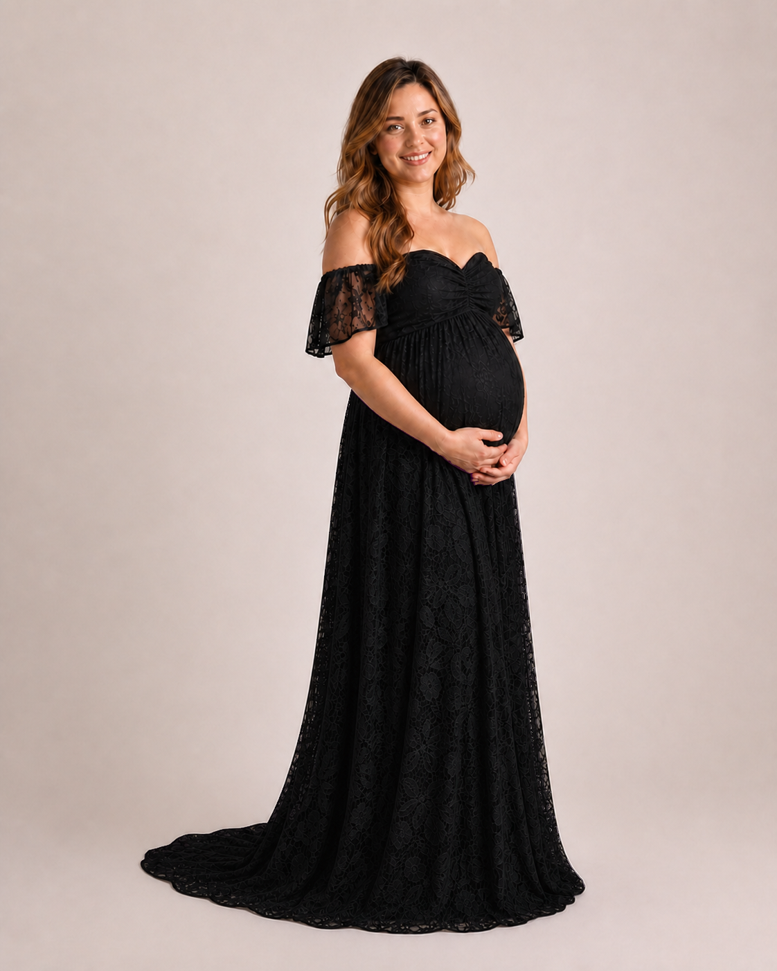 Black maternity gown at three-quarters, empire waist and A-line skirt in a studio stance