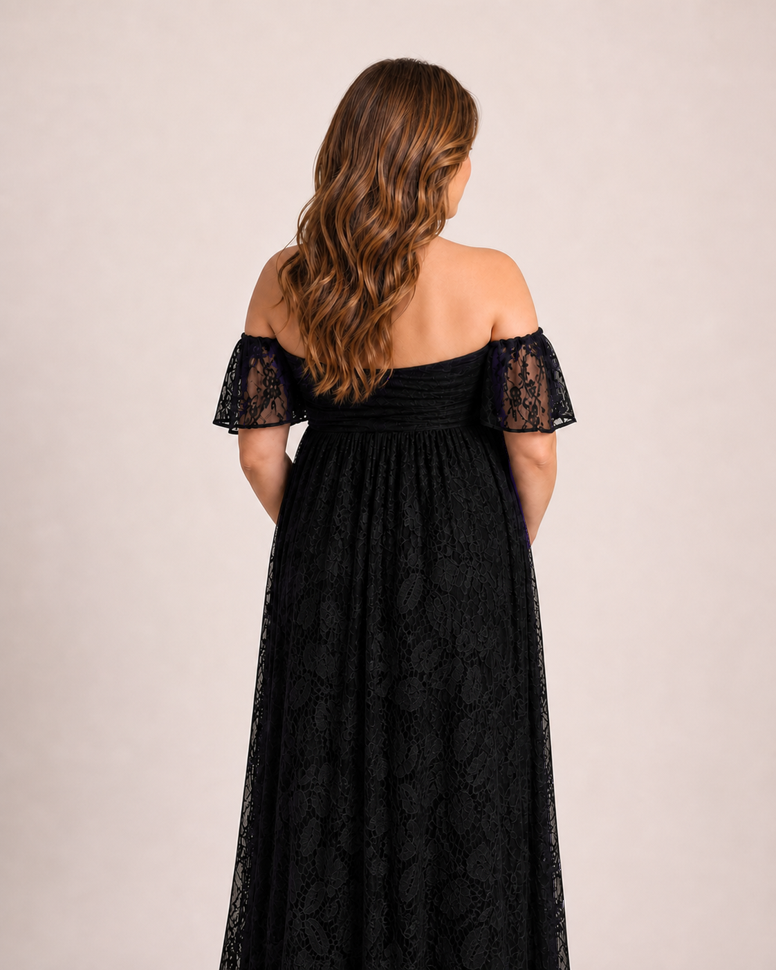 Black lace back view, flutter sleeves and a controlled longer hem behind the dress