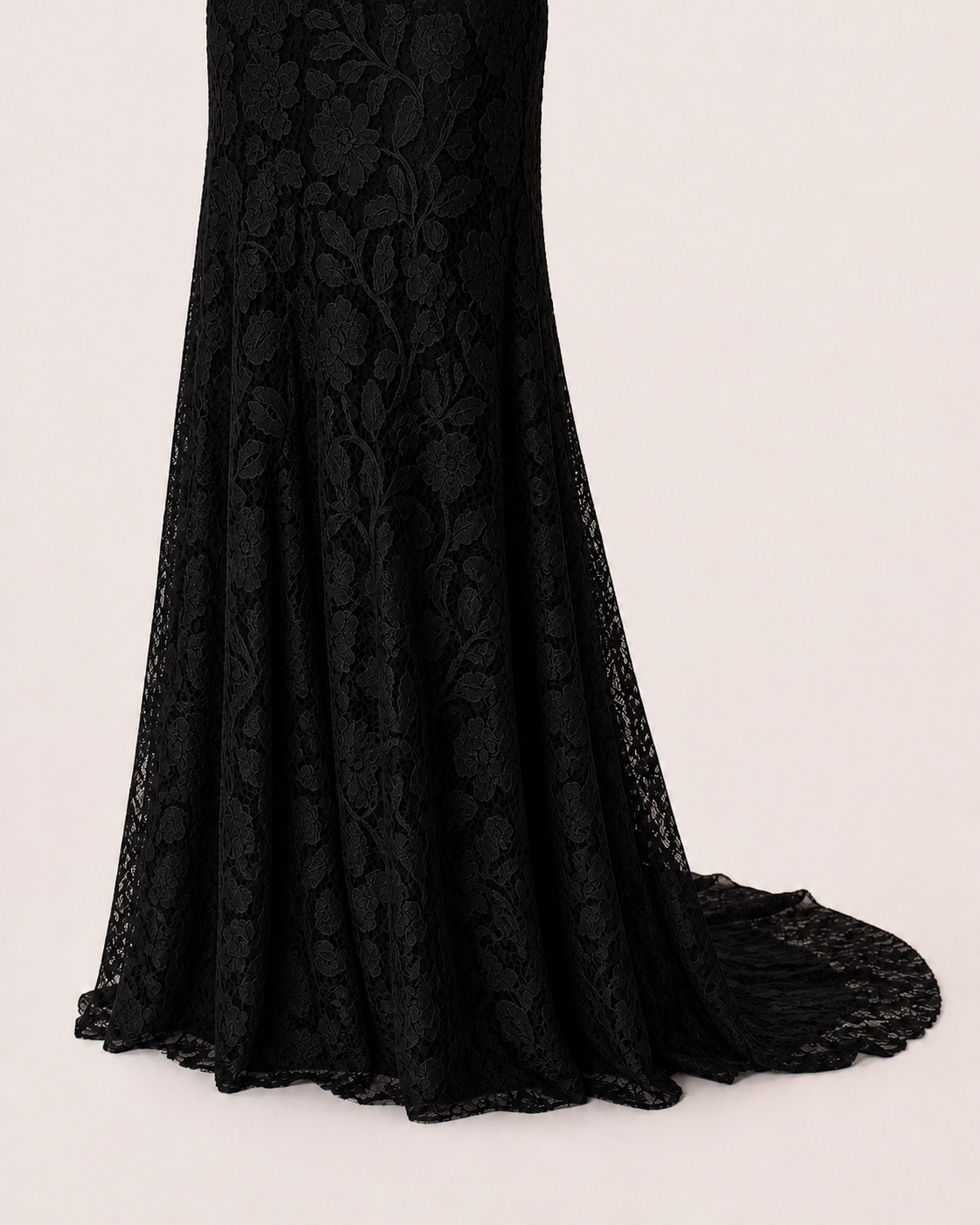 Black floor-length hem with extra back fabric falling in an open, unsymmetrical drape