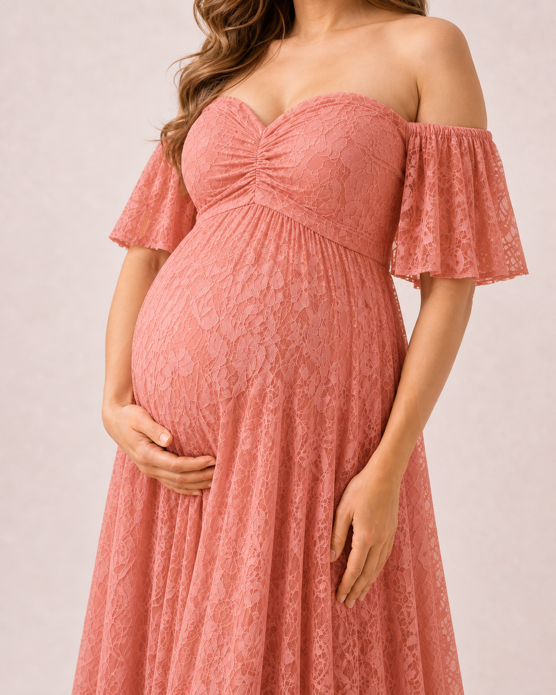 Coral-pink floral lace close-up, small blooms and leaves on a warm mesh ground