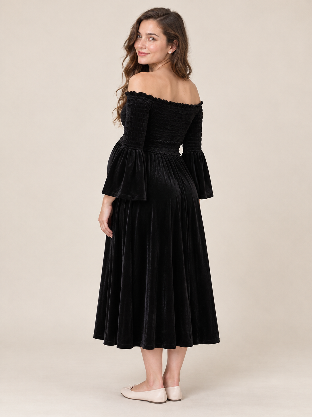 Talia Black maternity dress — three-quarter back view of the smocked bodice and bell sleeves