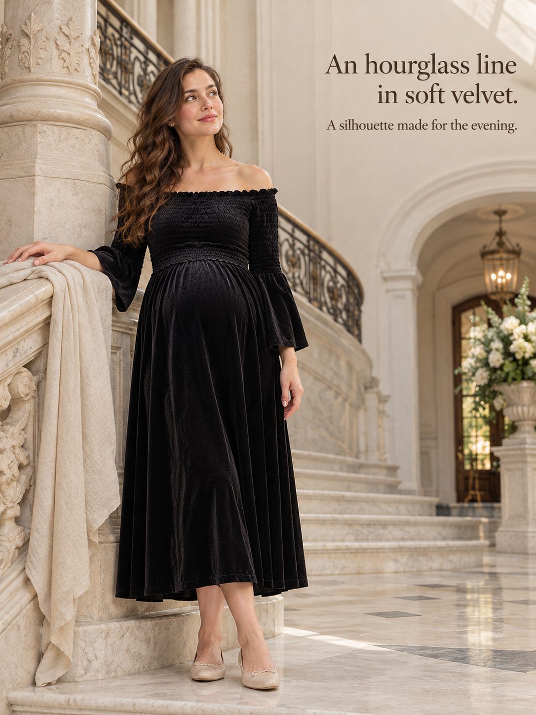 Talia Black maternity dress — descending a marble staircase holding a wrap