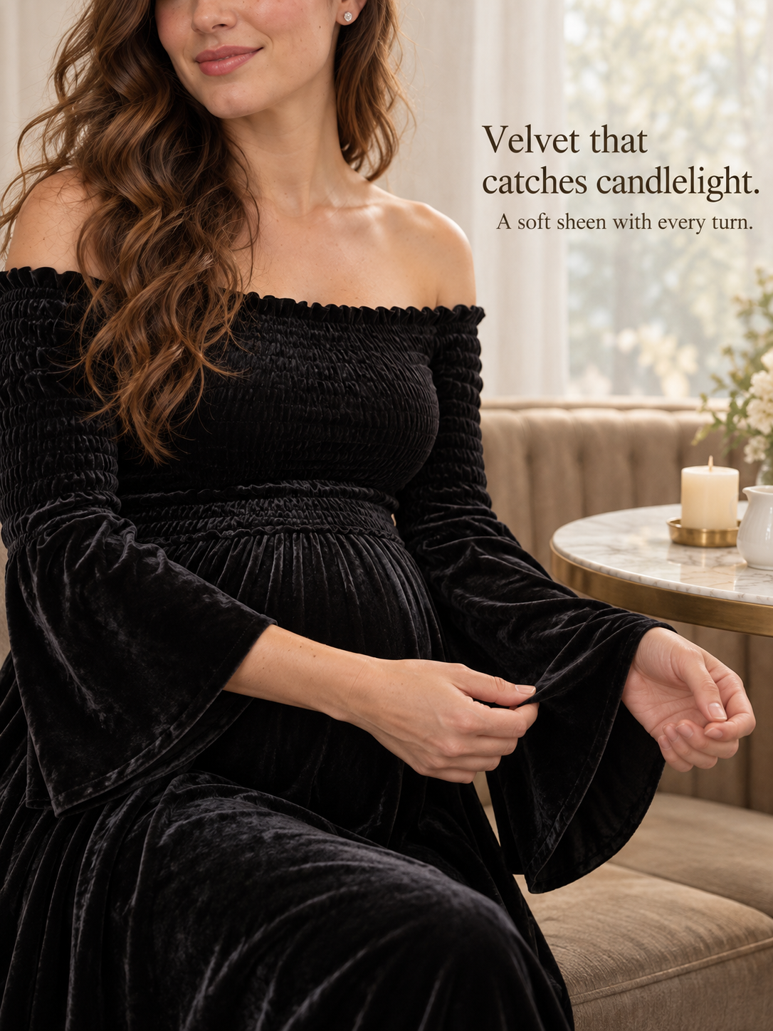 Talia Black maternity dress — sitting by candlelight on an ottoman in a living room