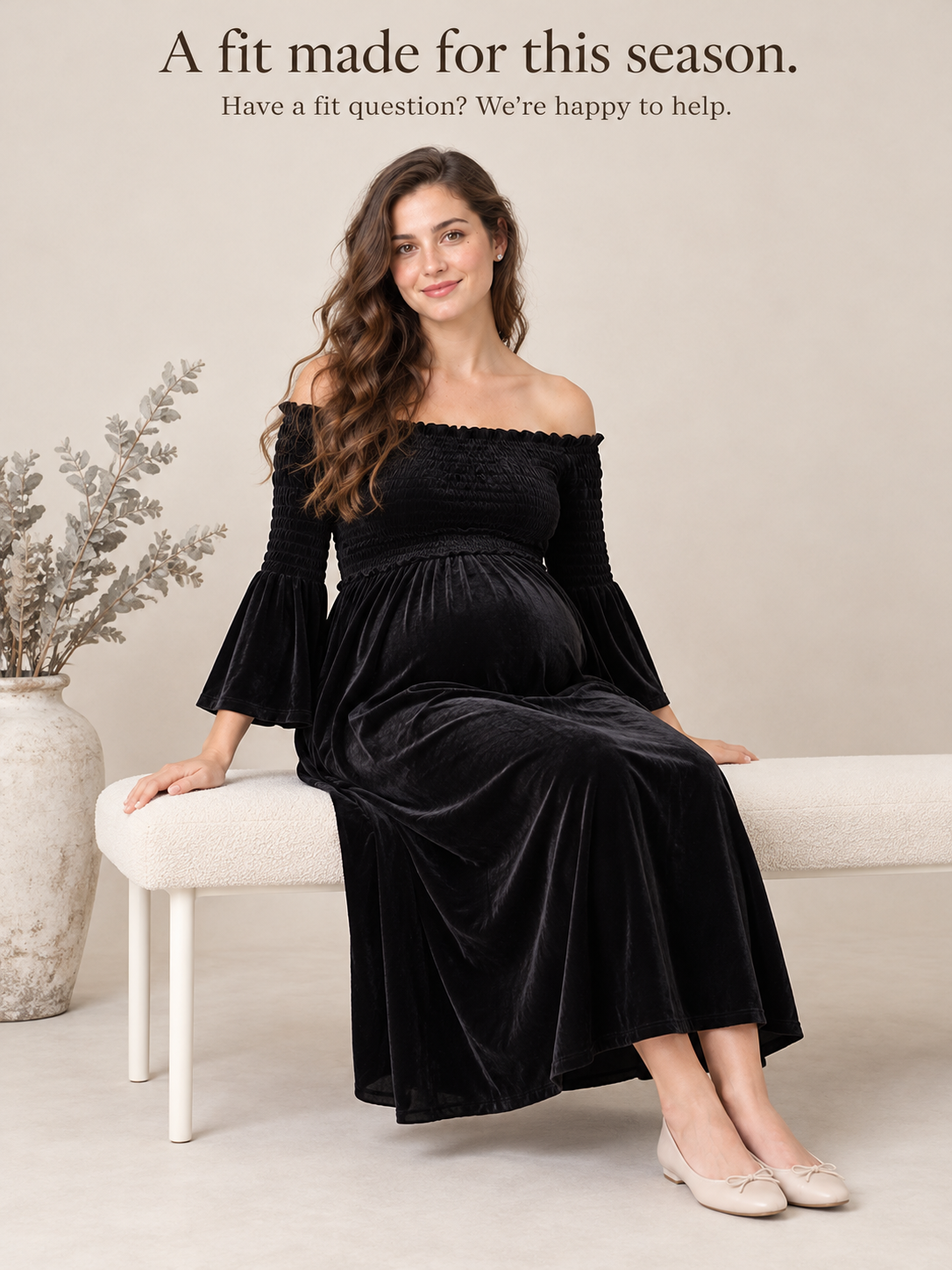 Talia Black maternity dress — sitting on a bench beside a dried flower arrangement