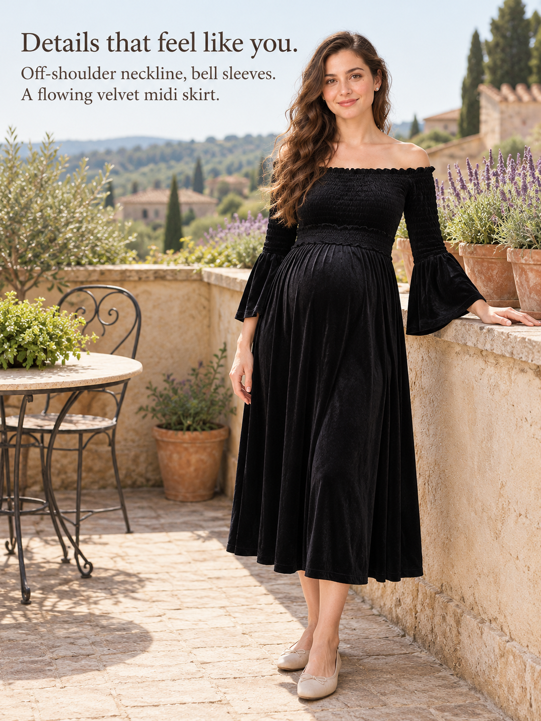 Talia Black maternity dress — standing on a stone terrace among olive trees
