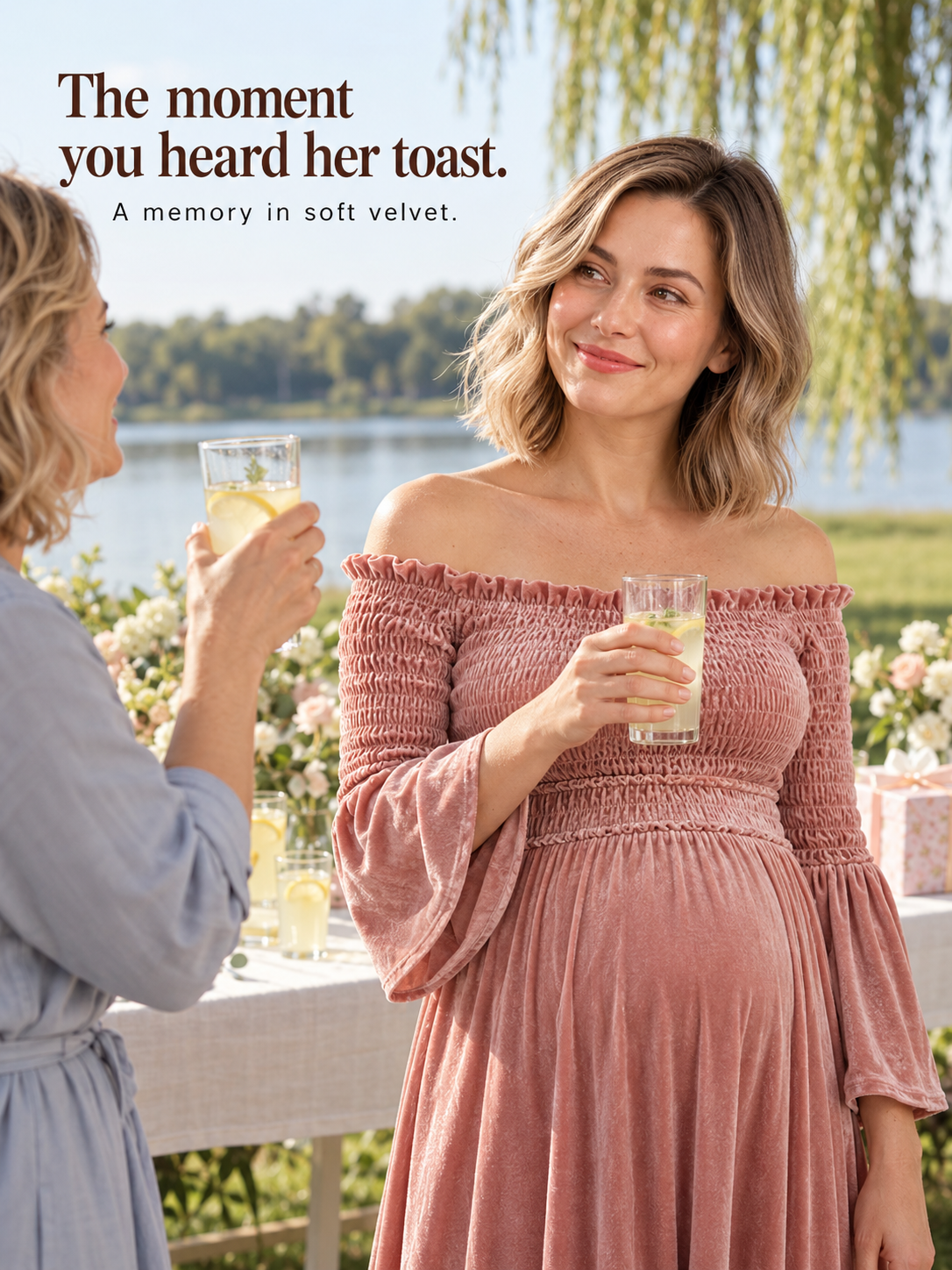 Talia Dusty Rose maternity dress — toasting with a friend beside a lake at sunset