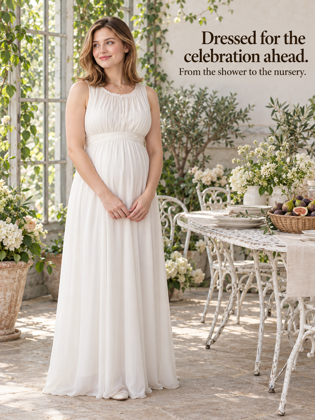 Annelise Ivory maternity dress — standing at an outdoor table set for a celebration