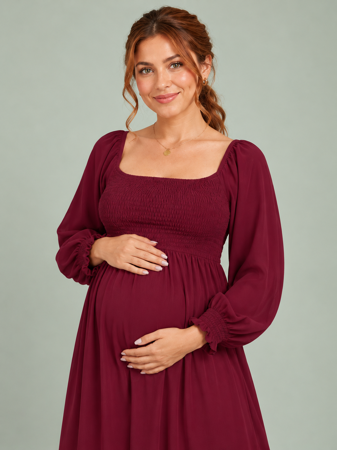 Cecily Wine Red maternity dress — bishop sleeve and shirred bodice, hand on the bump