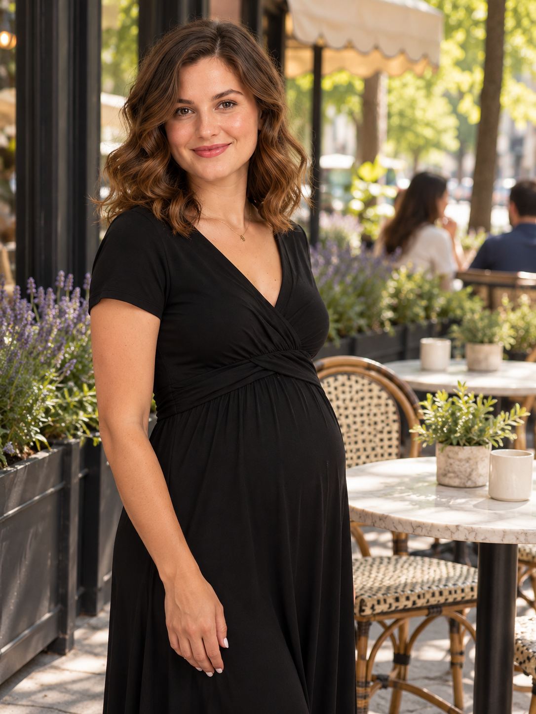 Lydia Black maternity dress — standing on a sidewalk outside a café
