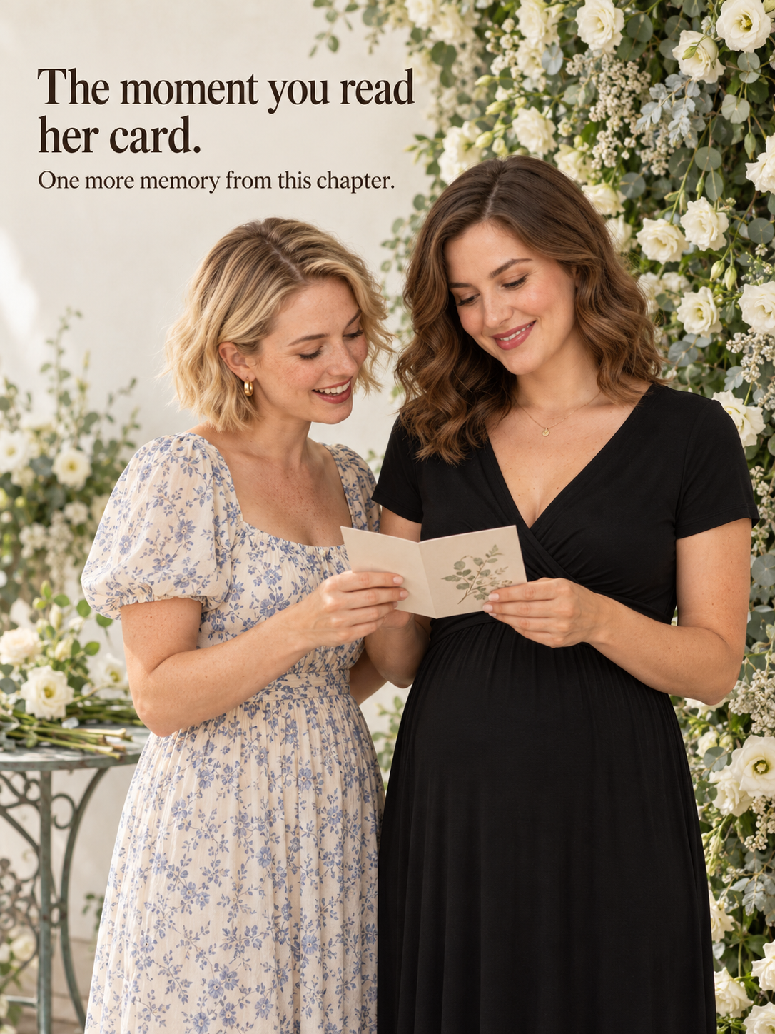 Lydia Black maternity dress — reading a card with a friend by a flower wall