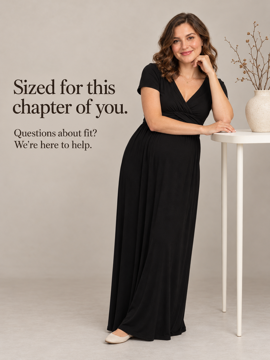 Lydia Black maternity dress — standing indoors beside a small table with flowers