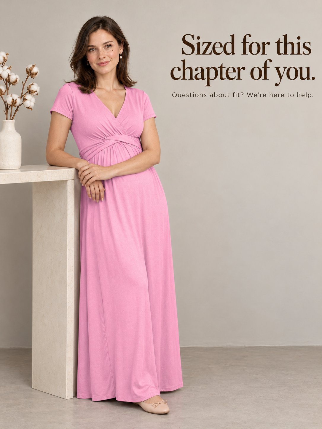 Lydia Rose maternity dress — standing indoors beside a vase of cotton stems