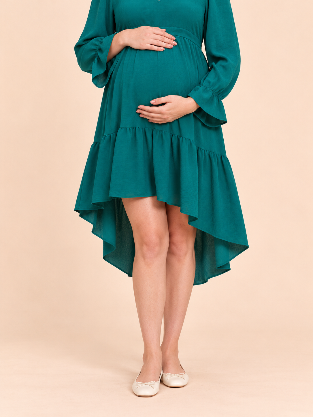 Mila Emerald maternity dress — tiered skirt and curved hem close-up
