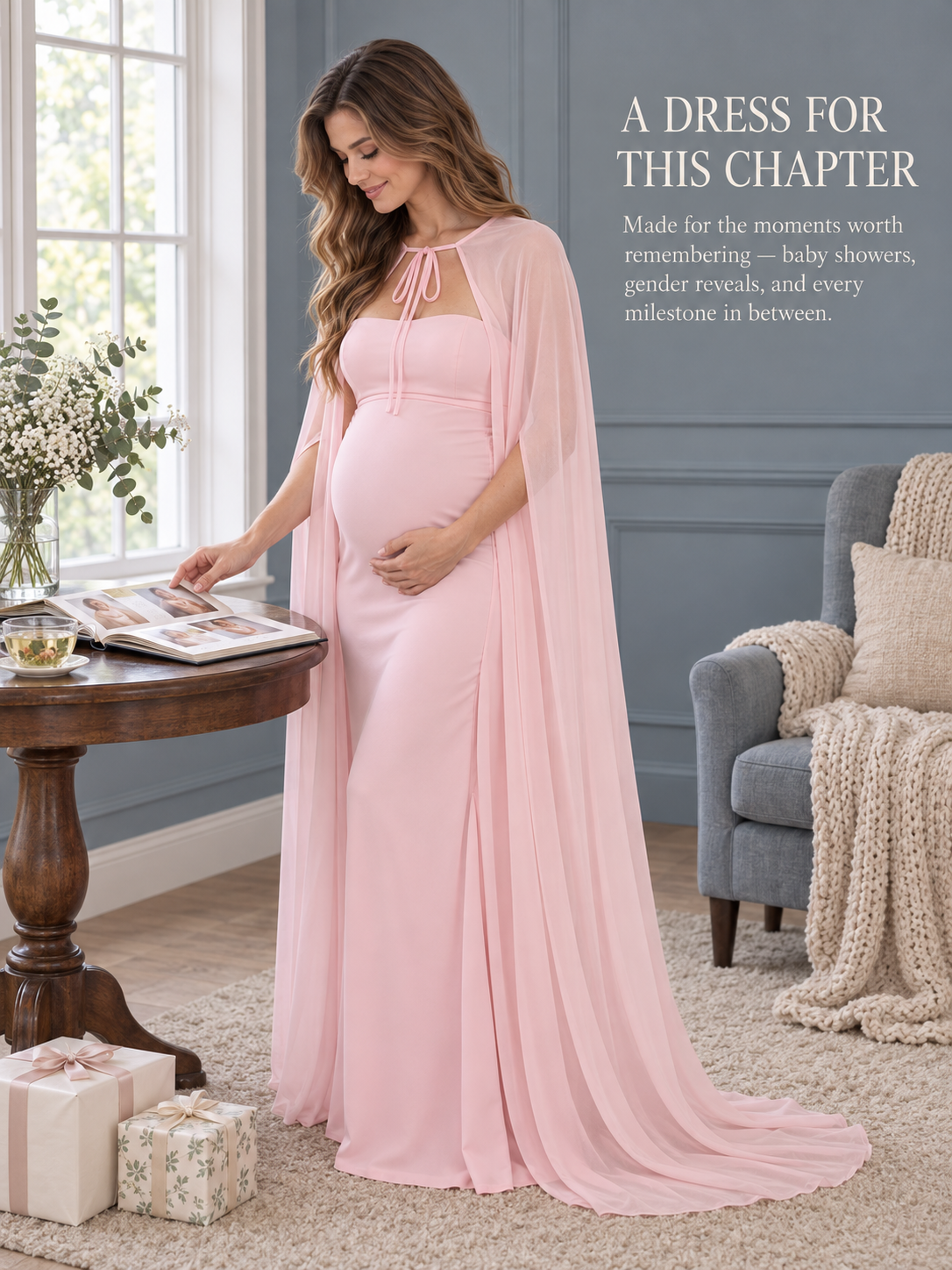 Rosamund Light Pink maternity dress — turning the pages of a photo album beside wrapped gifts