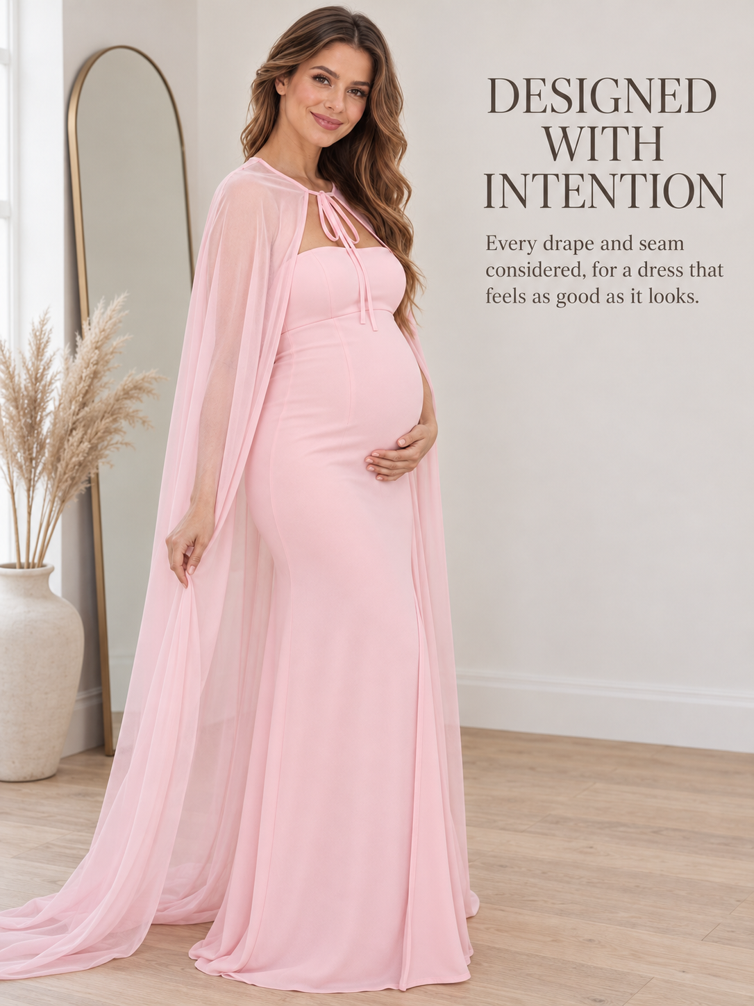 Rosamund Light Pink maternity dress — standing by an arched mirror in a calm neutral room