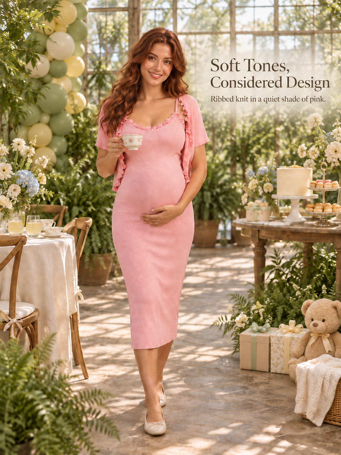 Bonnie Soft Pink maternity dress — holding a teacup at a garden celebration