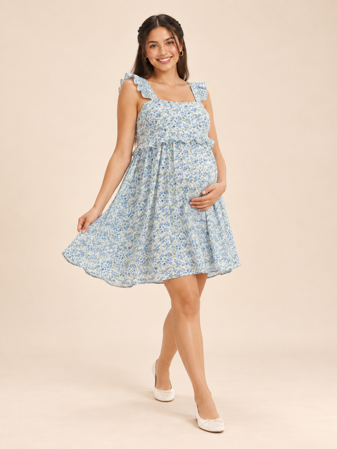 Romy Blue Floral maternity dress — twirling to show the gathered skirt above the knee