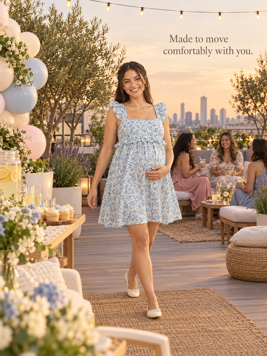 Romy Blue Floral maternity dress — walking across a rooftop terrace party at sunset