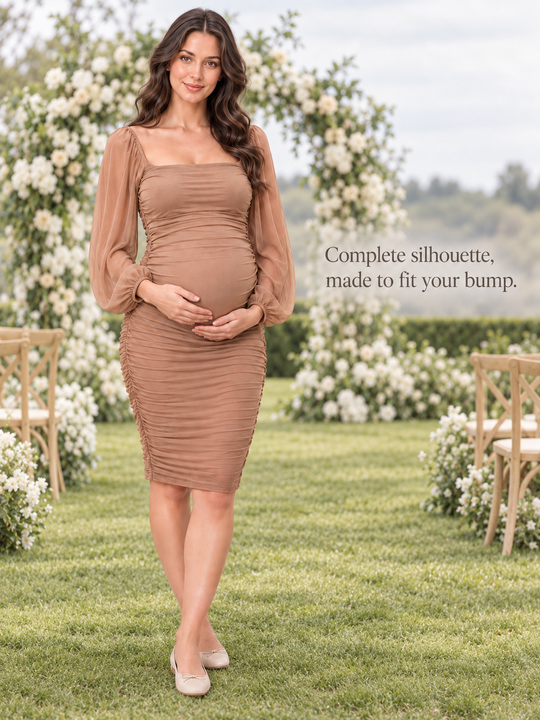 Hazel Camel maternity dress — full silhouette in a flower garden