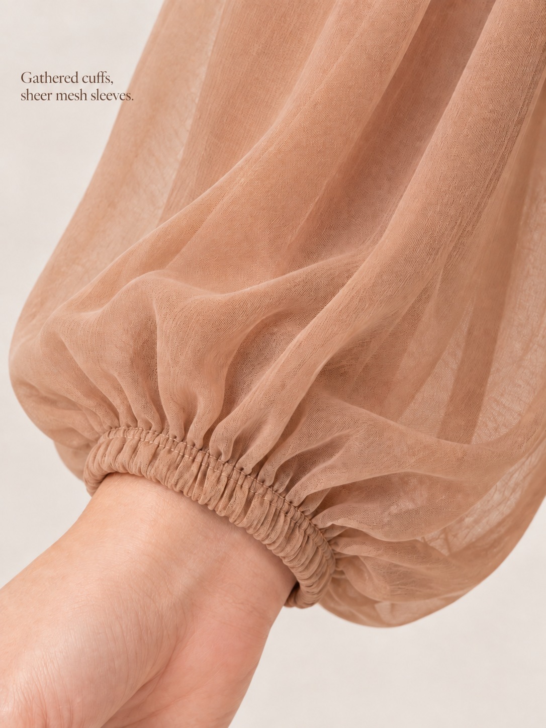 Hazel Camel maternity dress — elastic gathered cuff on a sheer mesh sleeve