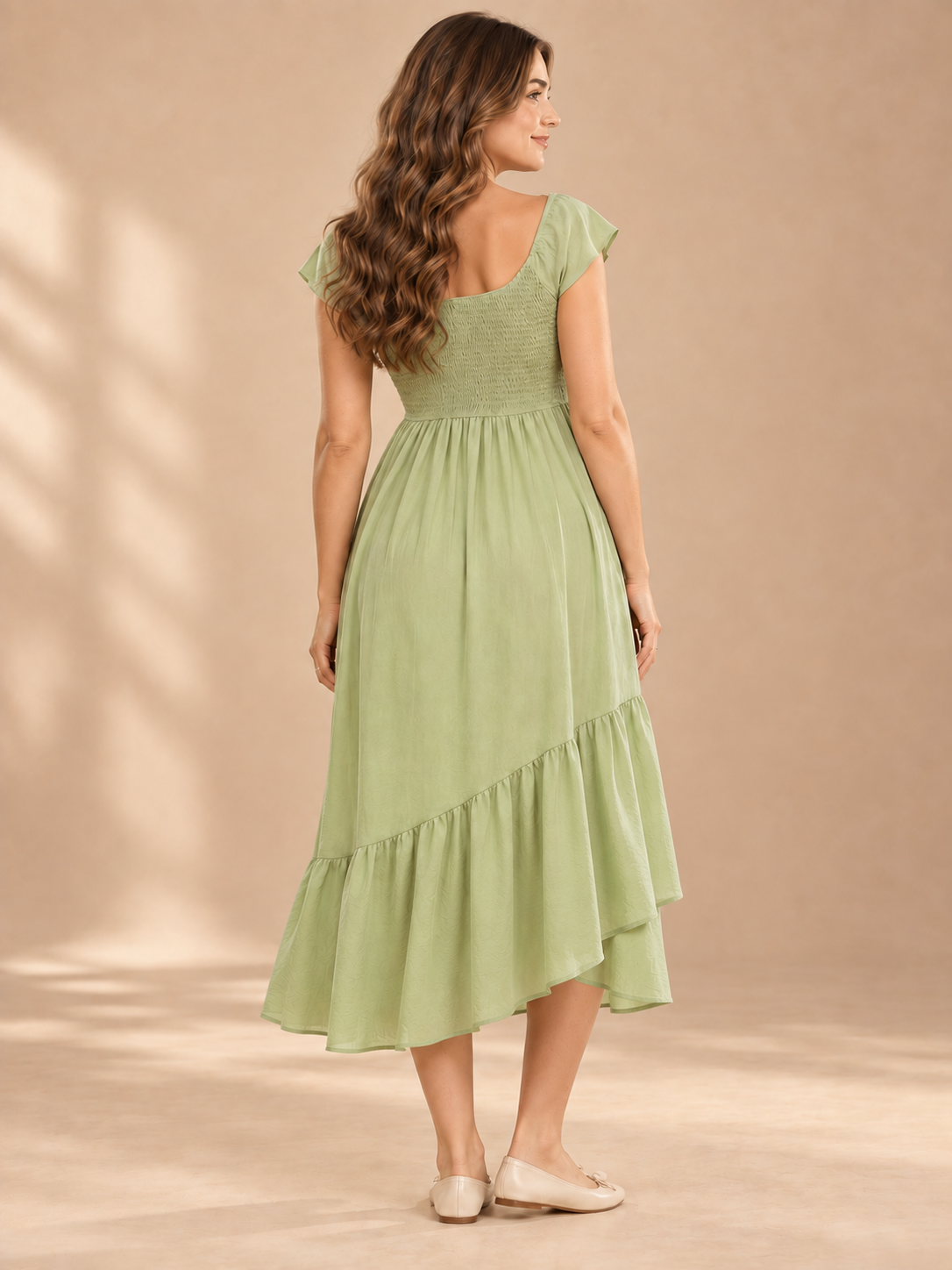 Juniper Sage Green maternity dress — back view of the smocked bodice and longer back hem