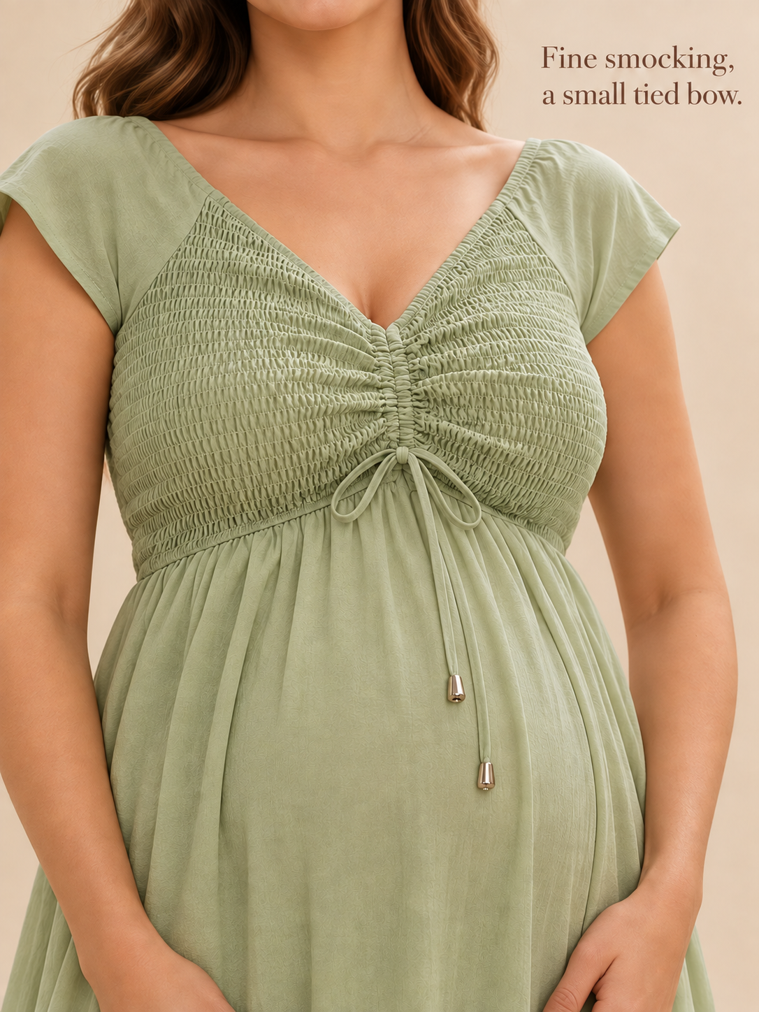 Juniper Sage Green maternity dress — close-up of the fine smocking and small tied bow