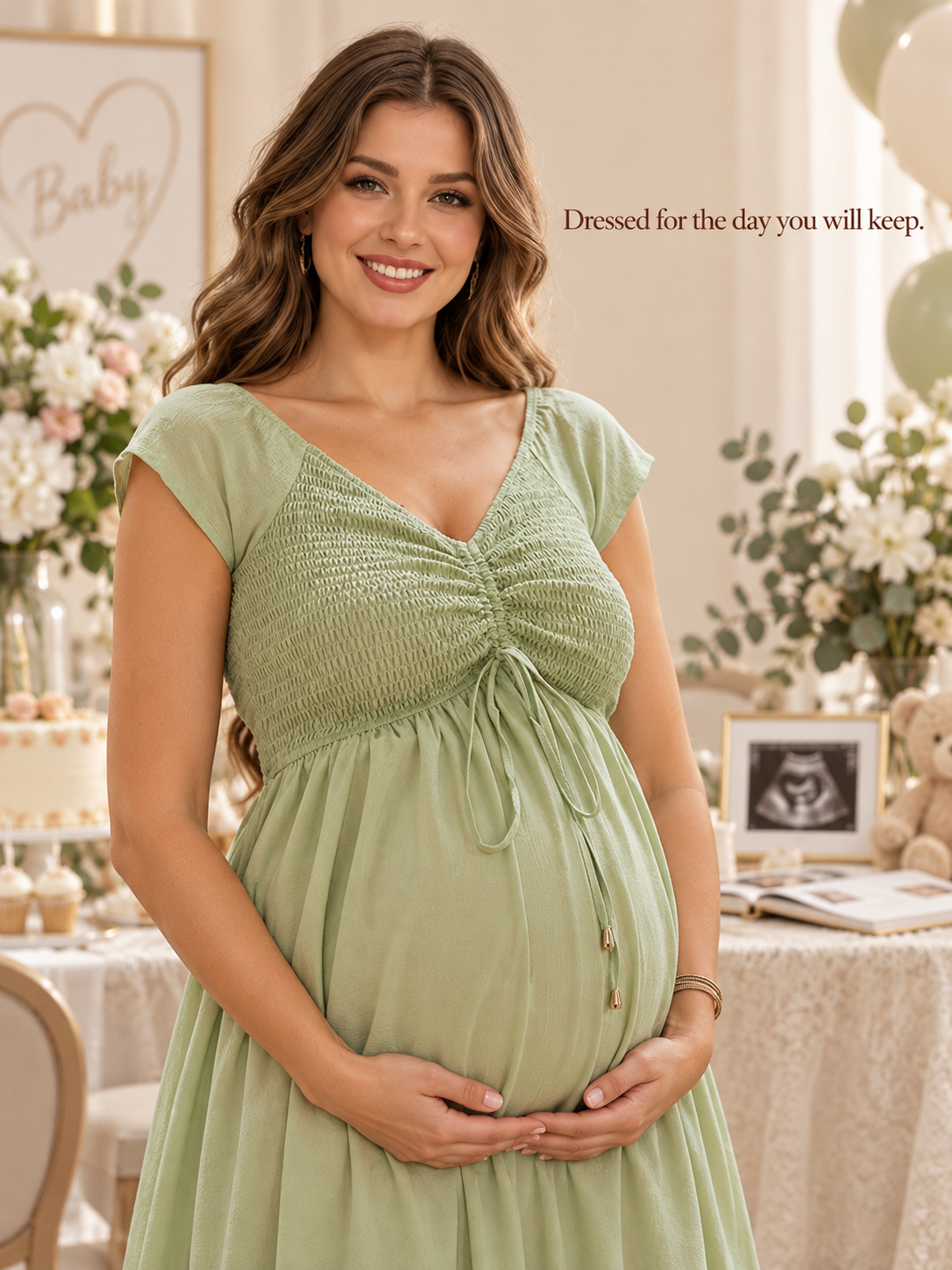 Juniper Sage Green maternity dress — smiling beside a baby shower welcome table