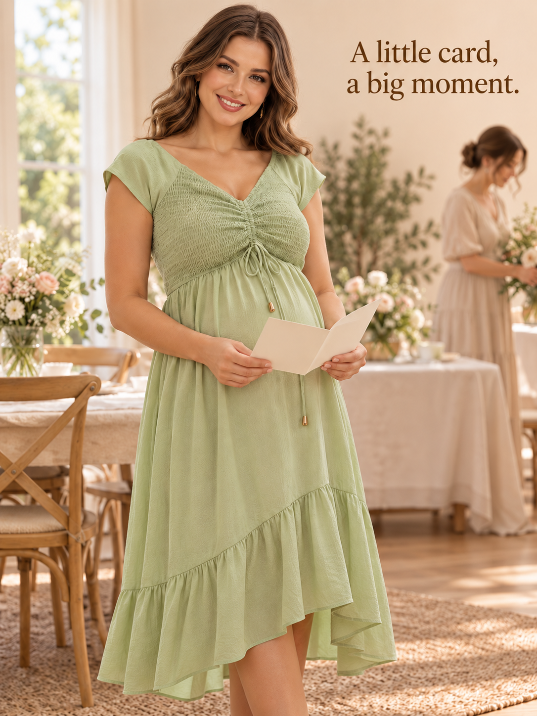 Juniper Sage Green maternity dress — reading a card from a loved one