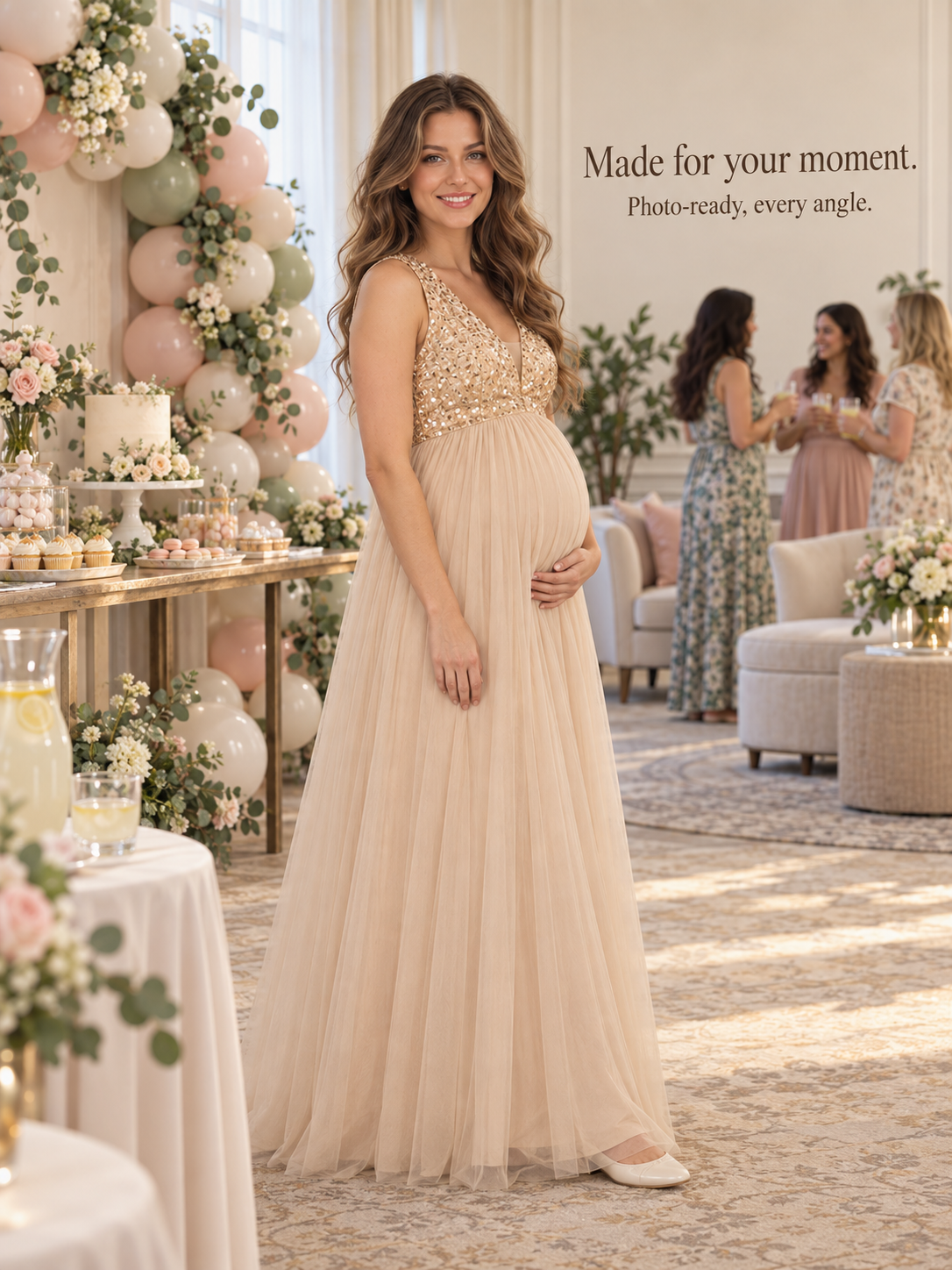 Ottilie Champagne Gold maternity dress — full silhouette beside a balloon arch and dessert table