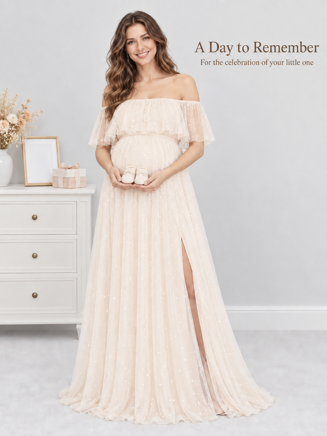Odette Apricot Cream maternity dress — holding tiny baby shoes beside a nursery dresser