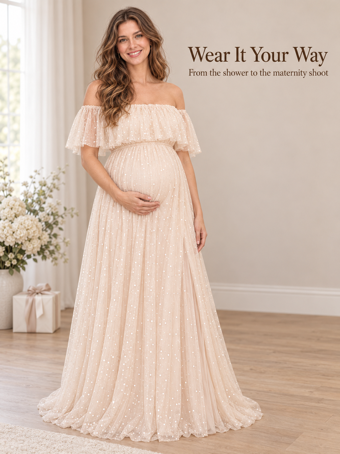 Odette Apricot Cream maternity dress — standing in a bright room with flowers and a gift