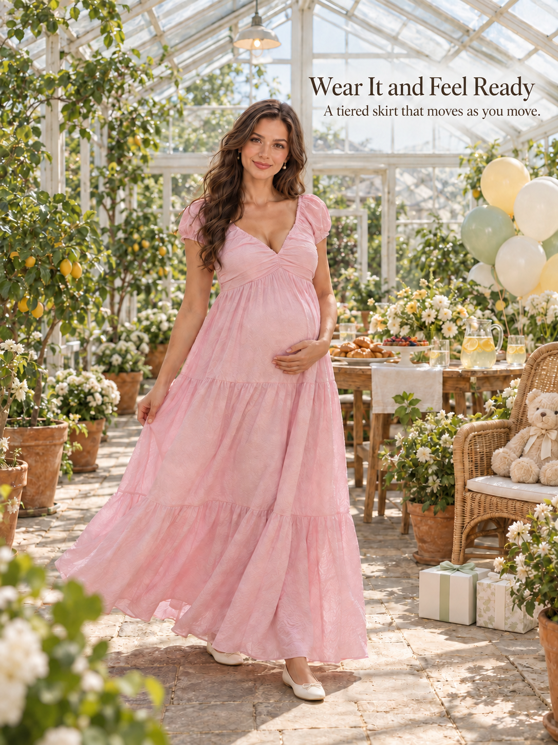 Adeline Baby Pink maternity dress — tiered skirt swaying in a sunlit glasshouse celebration