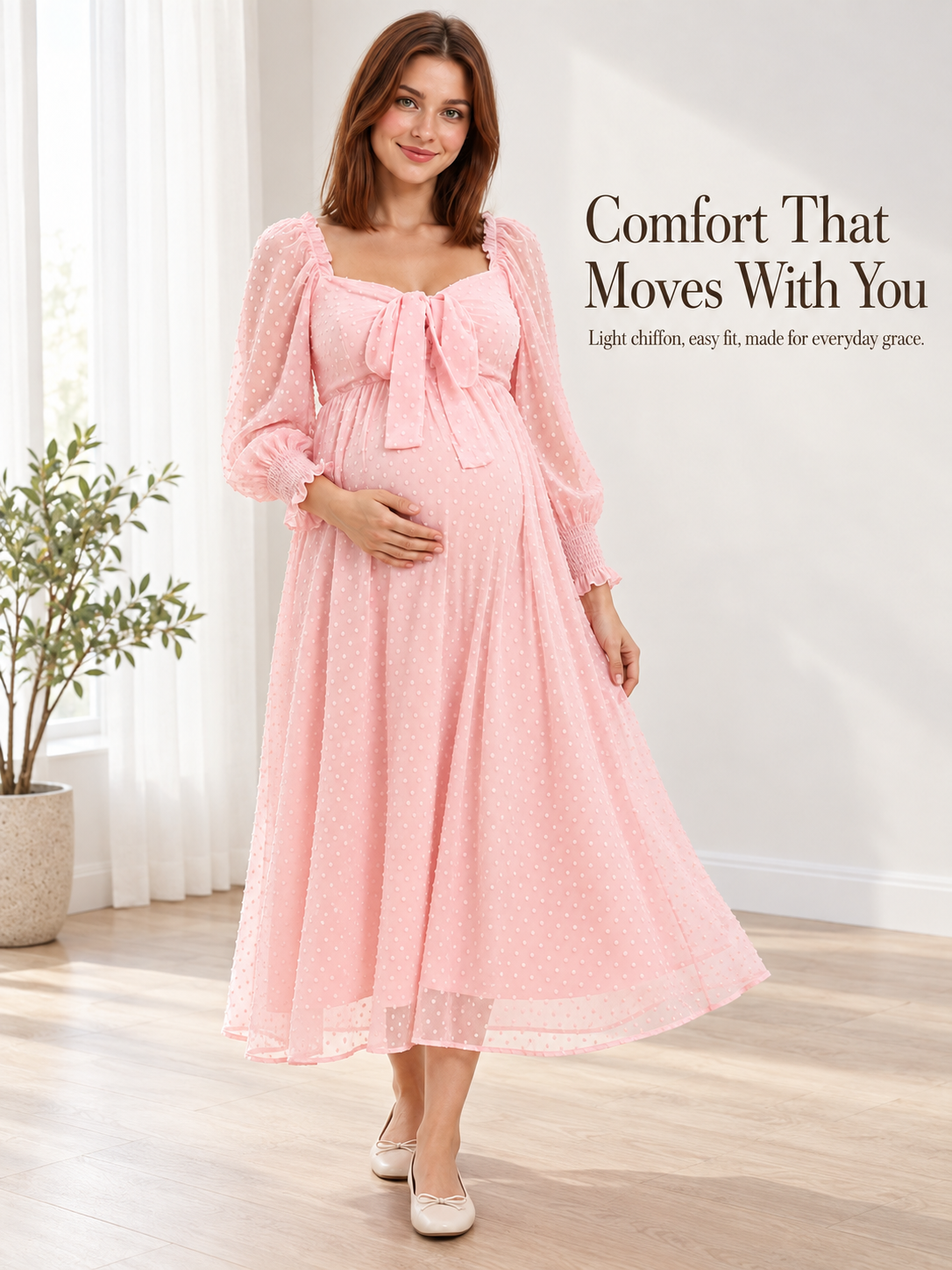 Emmeline Blush Pink maternity dress — walking in a bright room by sheer curtains