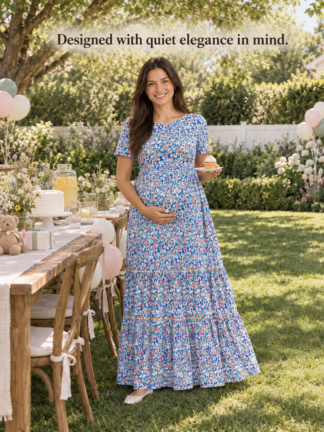Fleur Blue Floral maternity dress — BabyShowerDress brand story on a garden lawn