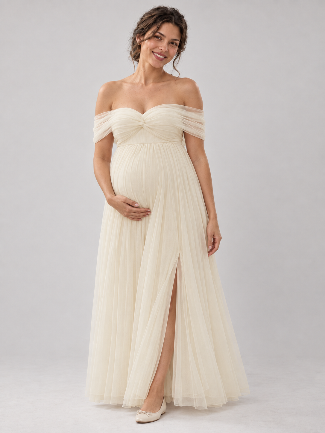 Front view of the Amelie apricot off-shoulder maternity dress with an empire waist and layered tulle skirt.