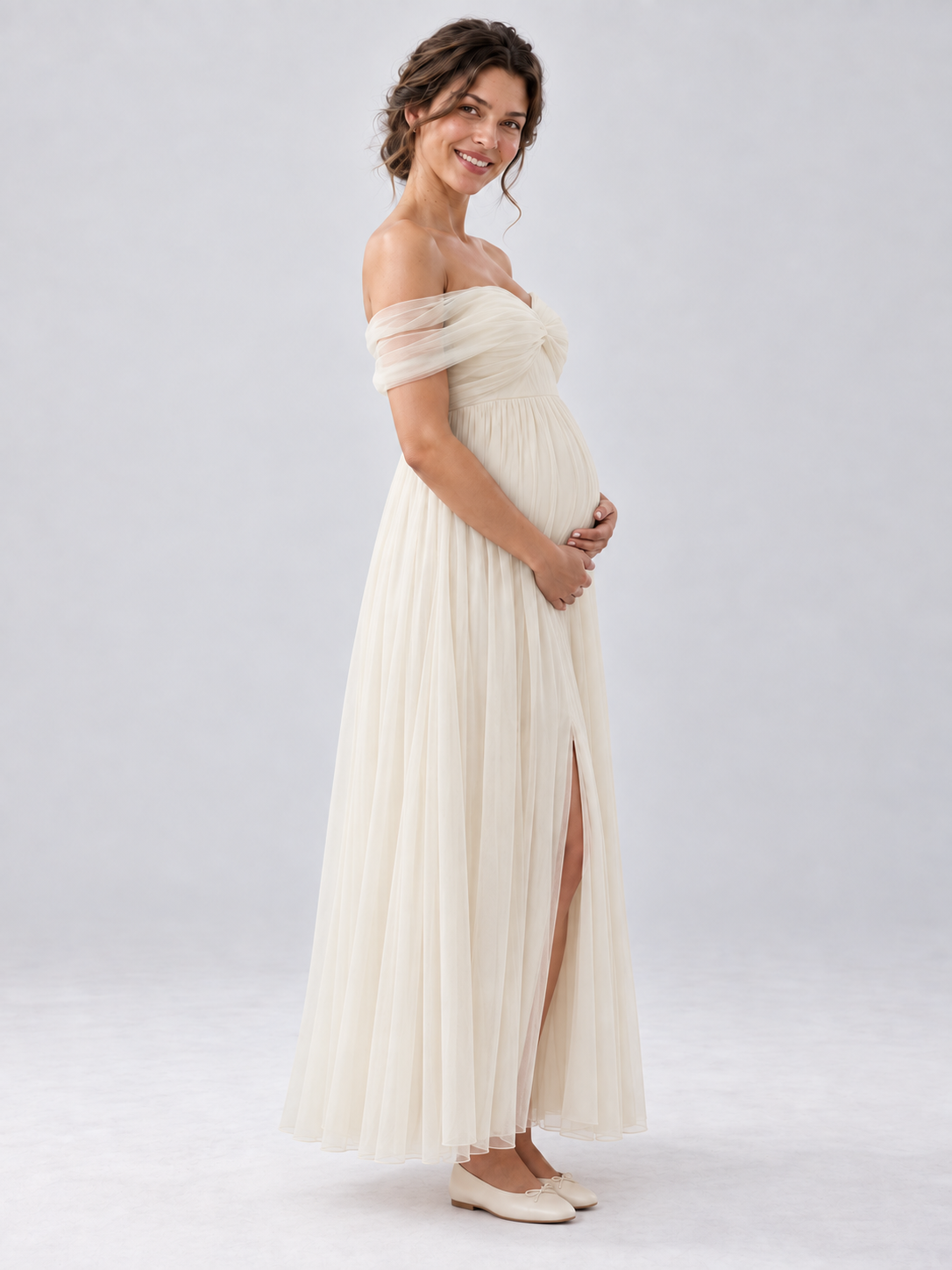 Side view of the Amelie apricot maternity dress showing the gathered skirt and raised waist.